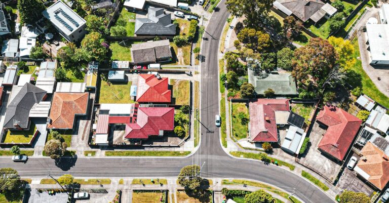 Drone shot of a vibrant austral nsw suburb showcasing houses and streets from above.